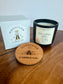 Montclair Candle Co. candle with lid and packaging on a wooden surface