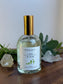 Bottle of 'Clear & Calm' product on a wooden surface with plants in the background