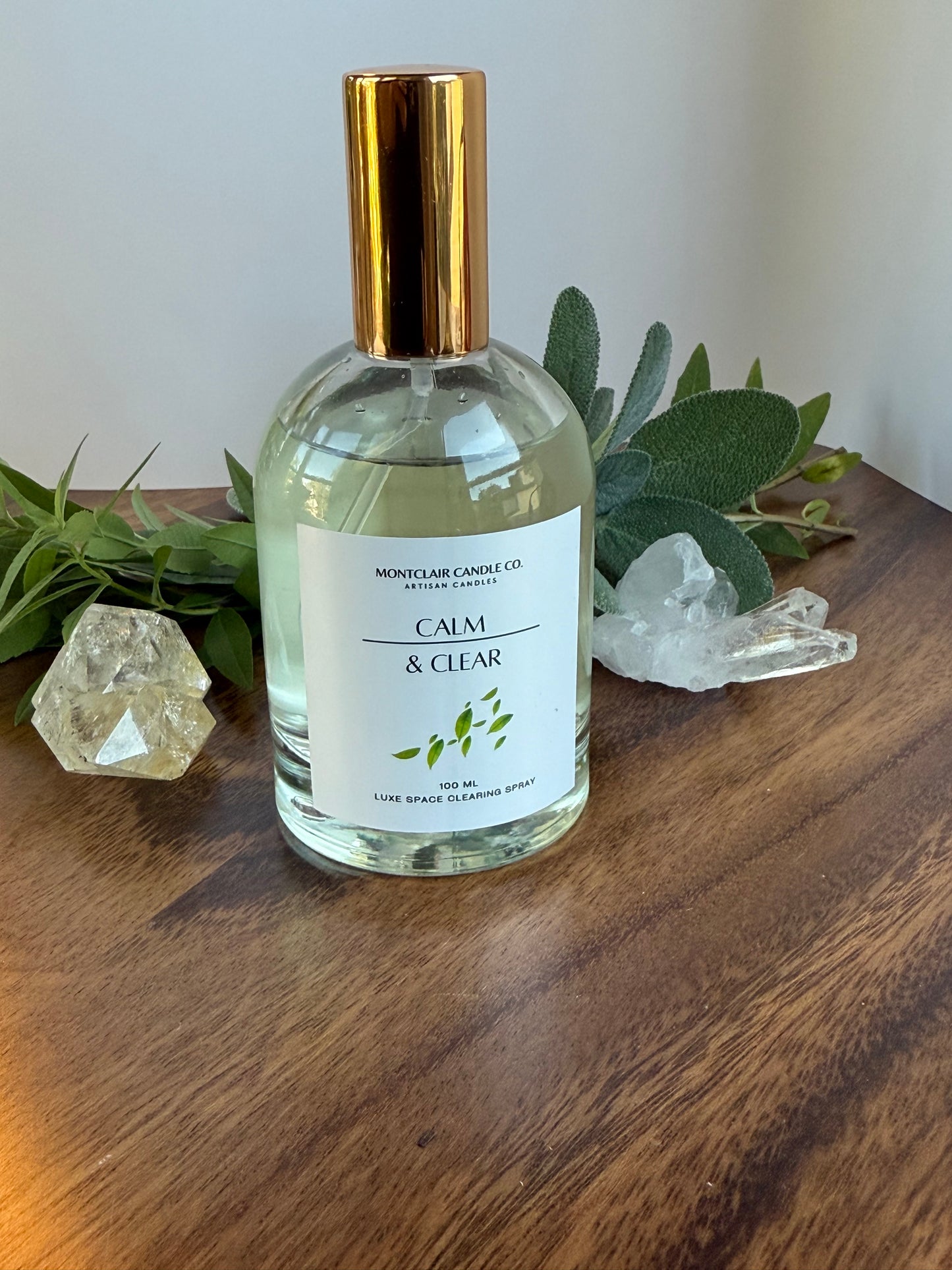 Bottle of 'Calm & Clear' product on a wooden surface with decorative elements