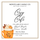 Montclair Candle Co. Cozy Cafe candle label with an orange mug illustration.
