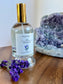Bottle of 'Zen Moments' diffuser with lavender flowers and a crystal on a wooden surface
