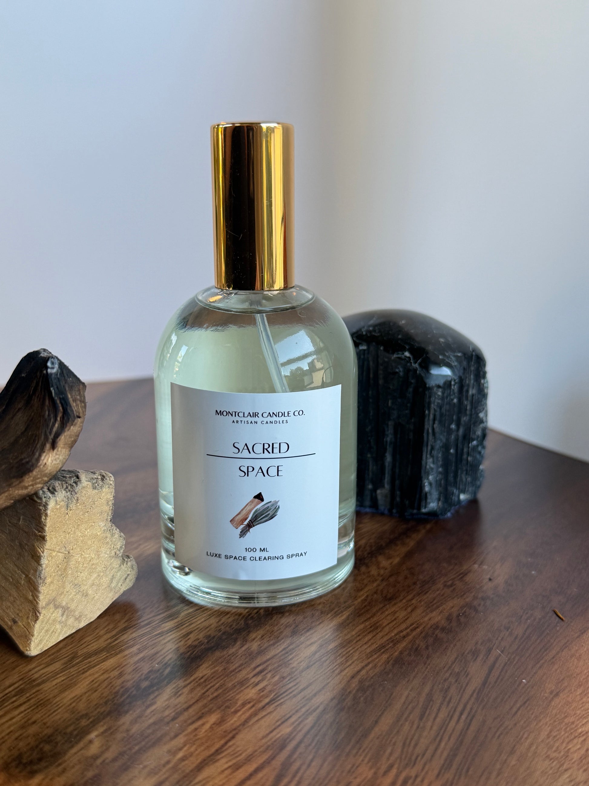 Perfume bottle with gold cap on a wooden surface